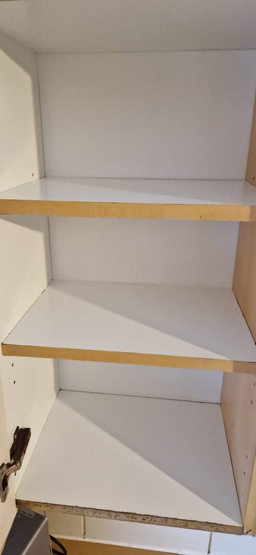 Kitchen cupboard shelves wiped clean inside