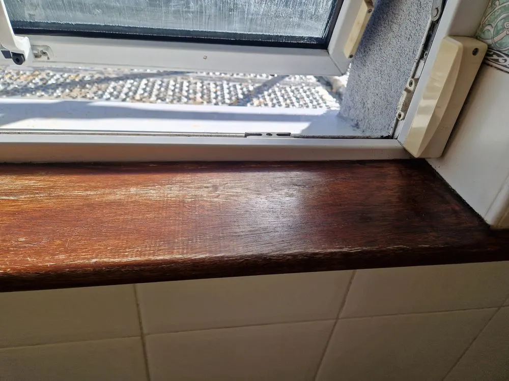 The same window sill after a bathroom deep clean in Dublin, with the wood clean and polished